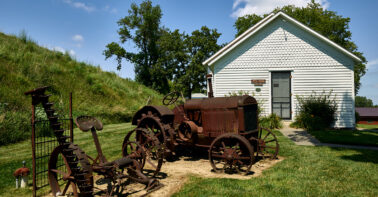 Rusted old farm equipment stands outside the one-room West Boyer Valley schoolhouse at the Harrison County Historical Village and Iowa Welcome Center, outside the town of Missouri Valley on U.S. Highway 30, the historic Lincoln Highway that crosses the natio